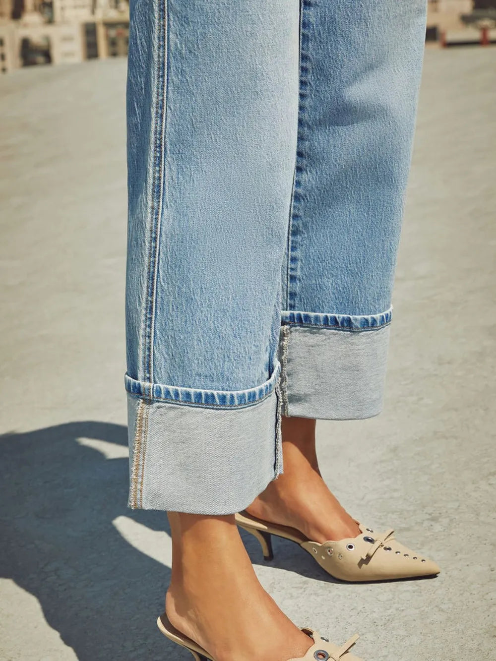 Medium wash high waisted straight leg rolled jeans by Trendsi, featuring classic denim with a relaxed fit and rolled cuff details.