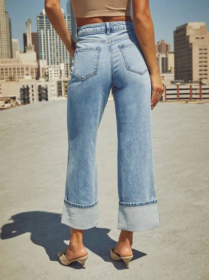 Medium wash high waisted straight leg jeans with rolled cuffs from Trendsi, displayed on a neutral background.