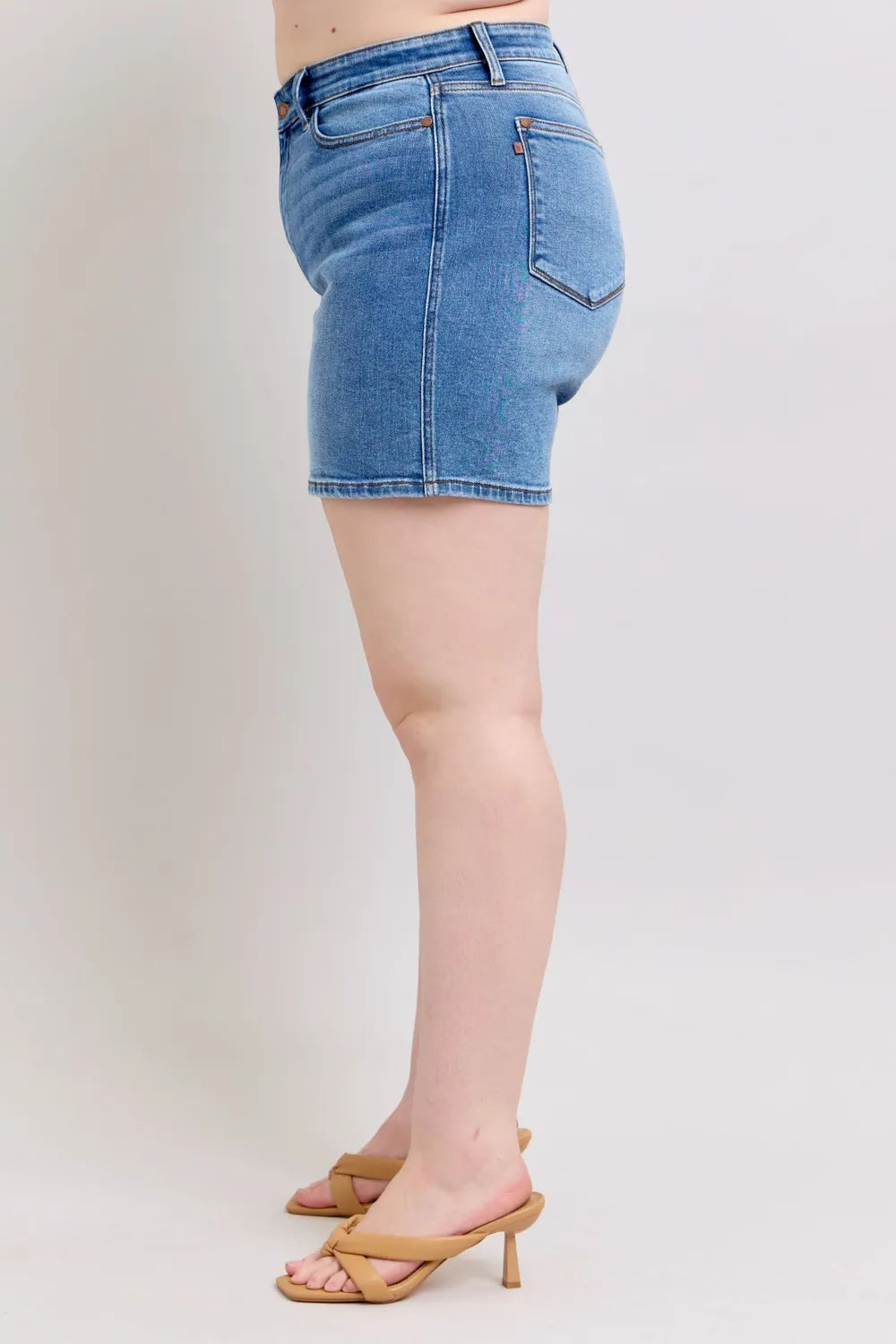 Plus size Judy Blue denim shorts with two-button closure and front pockets, featuring a casual fit and stylish design.