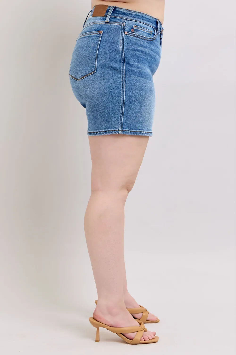 Plus size Judy Blue denim shorts with two buttons and pockets, featuring a full-size fit and stylish casual design.