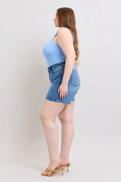 Plus size Judy Blue denim shorts with two buttons and front pockets, featuring a casual fit and medium wash.