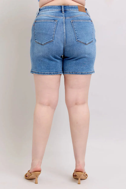 Plus size Judy Blue denim shorts with two buttons and pockets, featuring a full-size fit and stylish design.