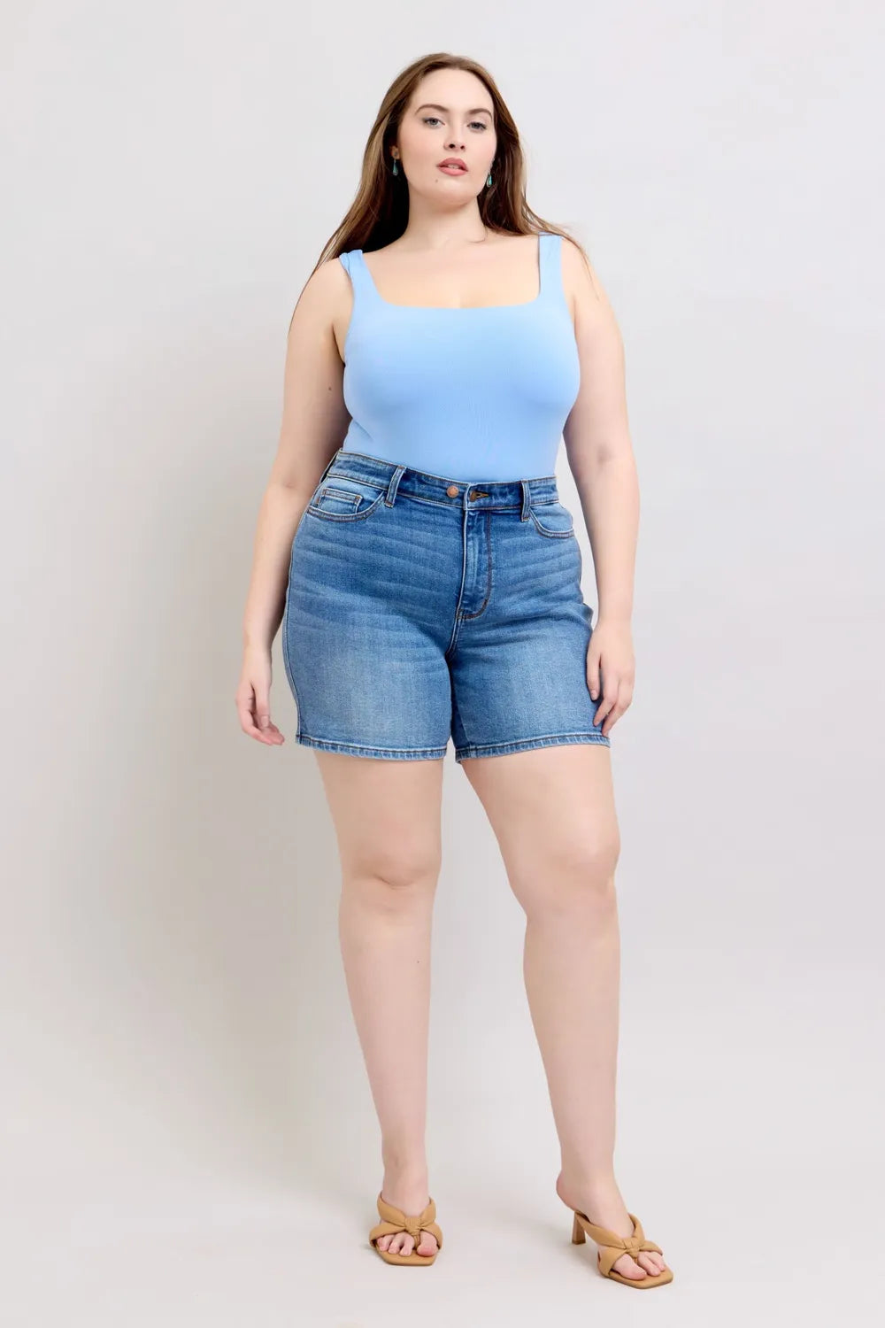 Plus size Judy Blue denim shorts with two-button closure and front pockets, featuring a casual fit and stylish design.