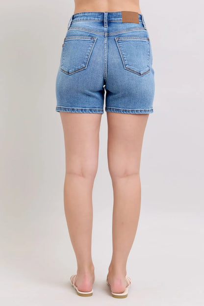Plus size Judy Blue denim shorts with two-button front and pockets, featuring a casual, stylish fit for women.