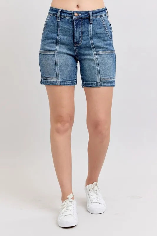 Plus size Judy Blue high-rise denim shorts with a medium wash and distressed details, designed for a flattering fit.