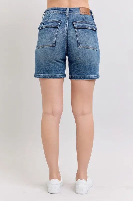 Plus size Judy Blue high rise denim shorts with a medium wash, featuring a classic five-pocket design and frayed hem.