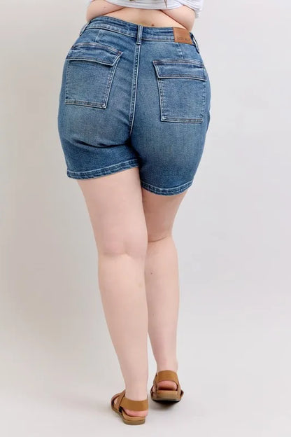Plus size Judy Blue high rise denim shorts with a classic fit and distressed details, perfect for casual summer wear.