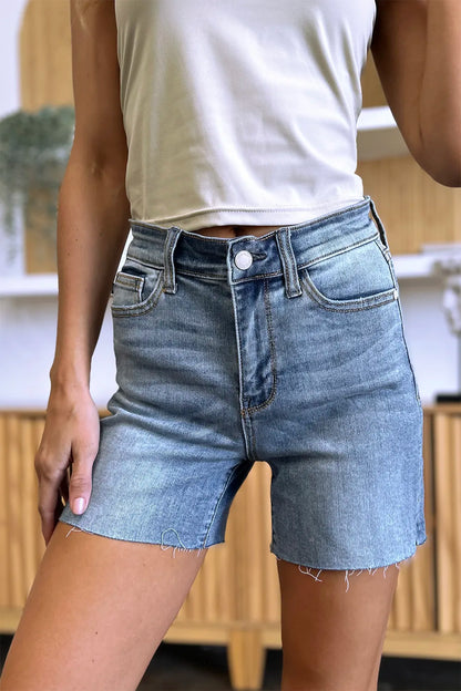 Full size Judy Blue high waist raw hem denim shorts with distressed details and classic blue wash, styled for casual summer wear.