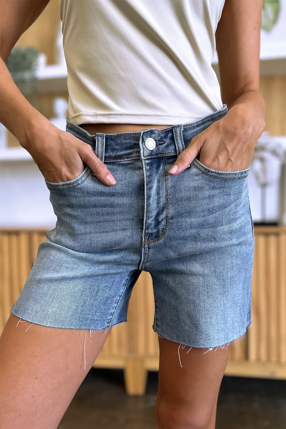 Full size Judy Blue high waist denim shorts with raw hem, showcasing trendy casual style and classic blue denim.
