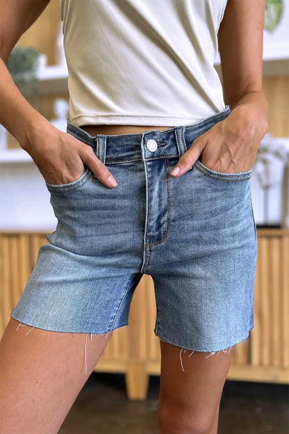 Full size Judy Blue high waist denim shorts with raw hem, showcasing trendy casual style and classic blue denim.
