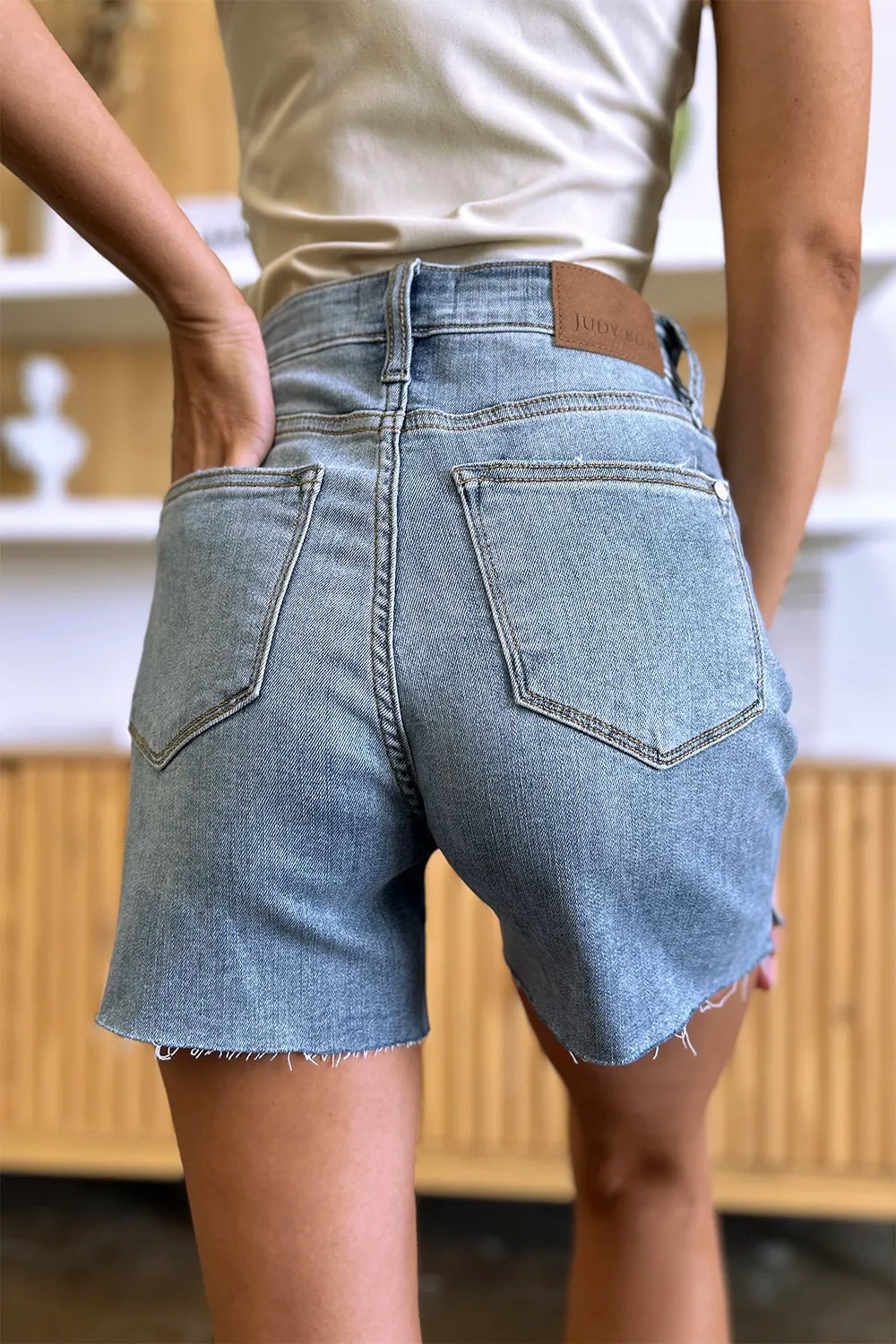 High waist Judy Blue raw hem denim shorts in full size, showcasing distressed details and classic blue denim.