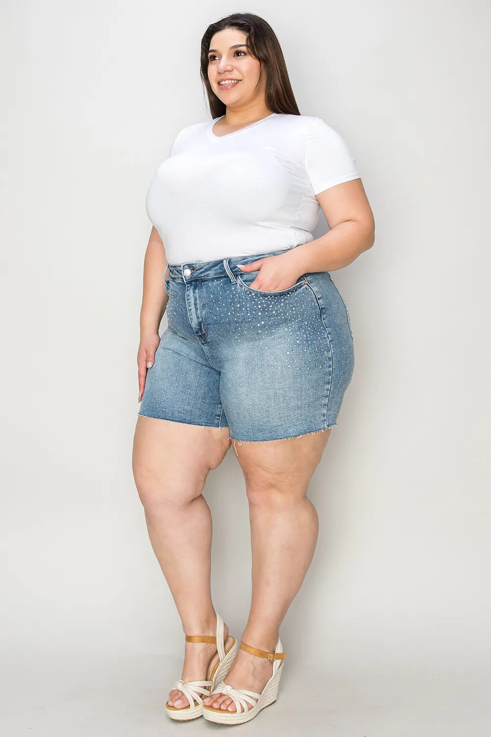 Light blue Judy Blue high waist denim shorts with raw hem, showcasing a stylish full-size fit and classic denim texture.