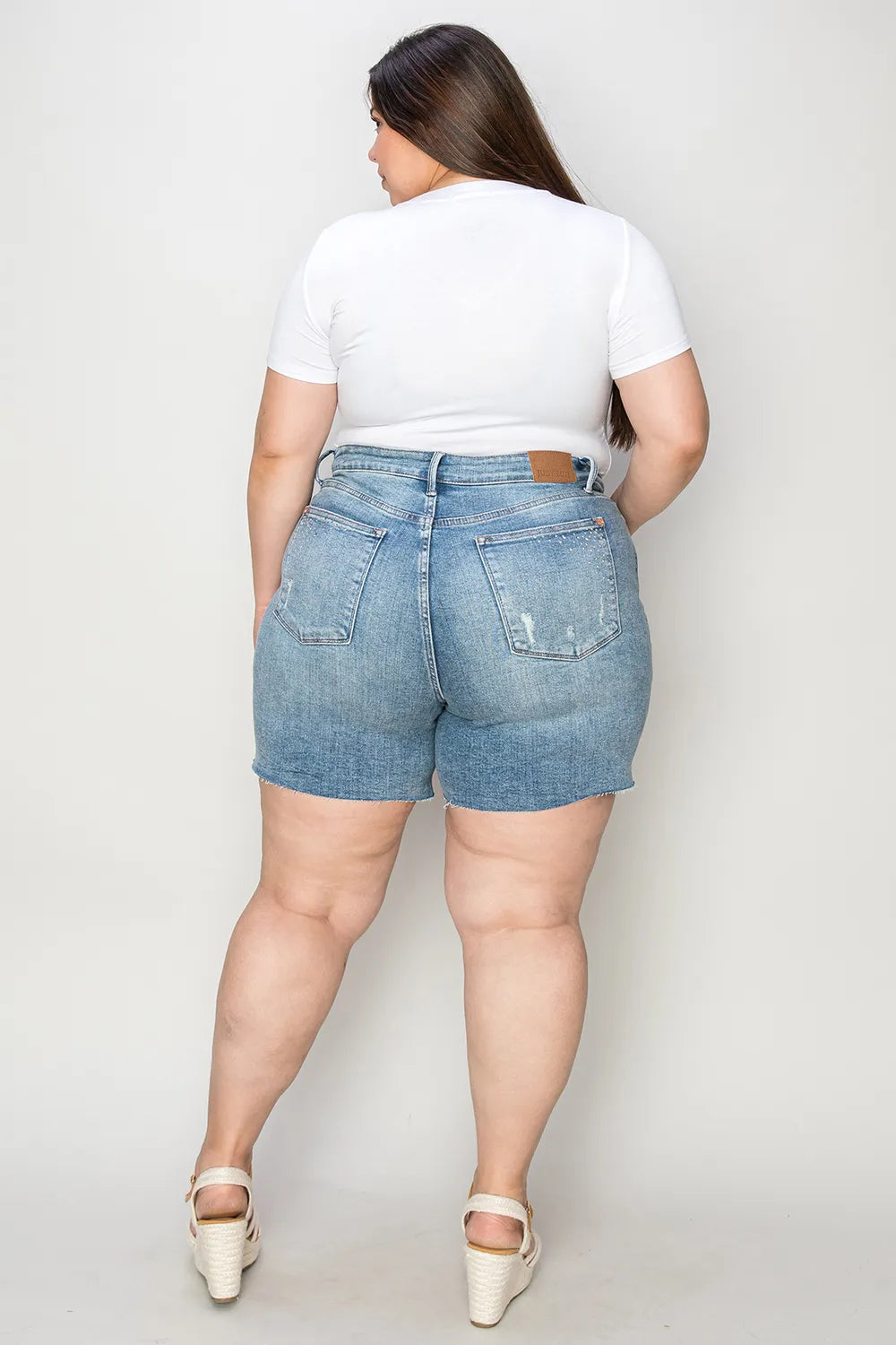 Judy Blue high waist raw hem denim shorts in medium size, featuring distressed details and a classic five-pocket design.