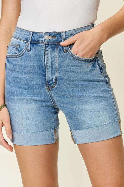 Judy Blue full-size high waist denim shorts with tummy control, shown in medium wash, featuring a stylish, fitted design.
