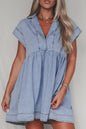 Light blue denim babydoll dress with lapel collar and cap sleeves, featuring a relaxed fit and casual style.