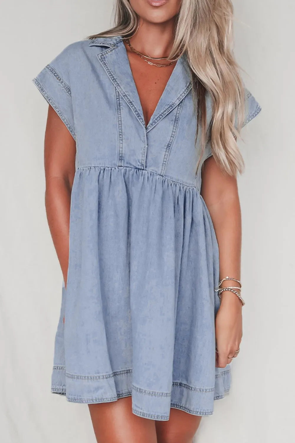 Medium-length denim babydoll dress with lapel neck and cap sleeves, stylish and casual from Trendsi.