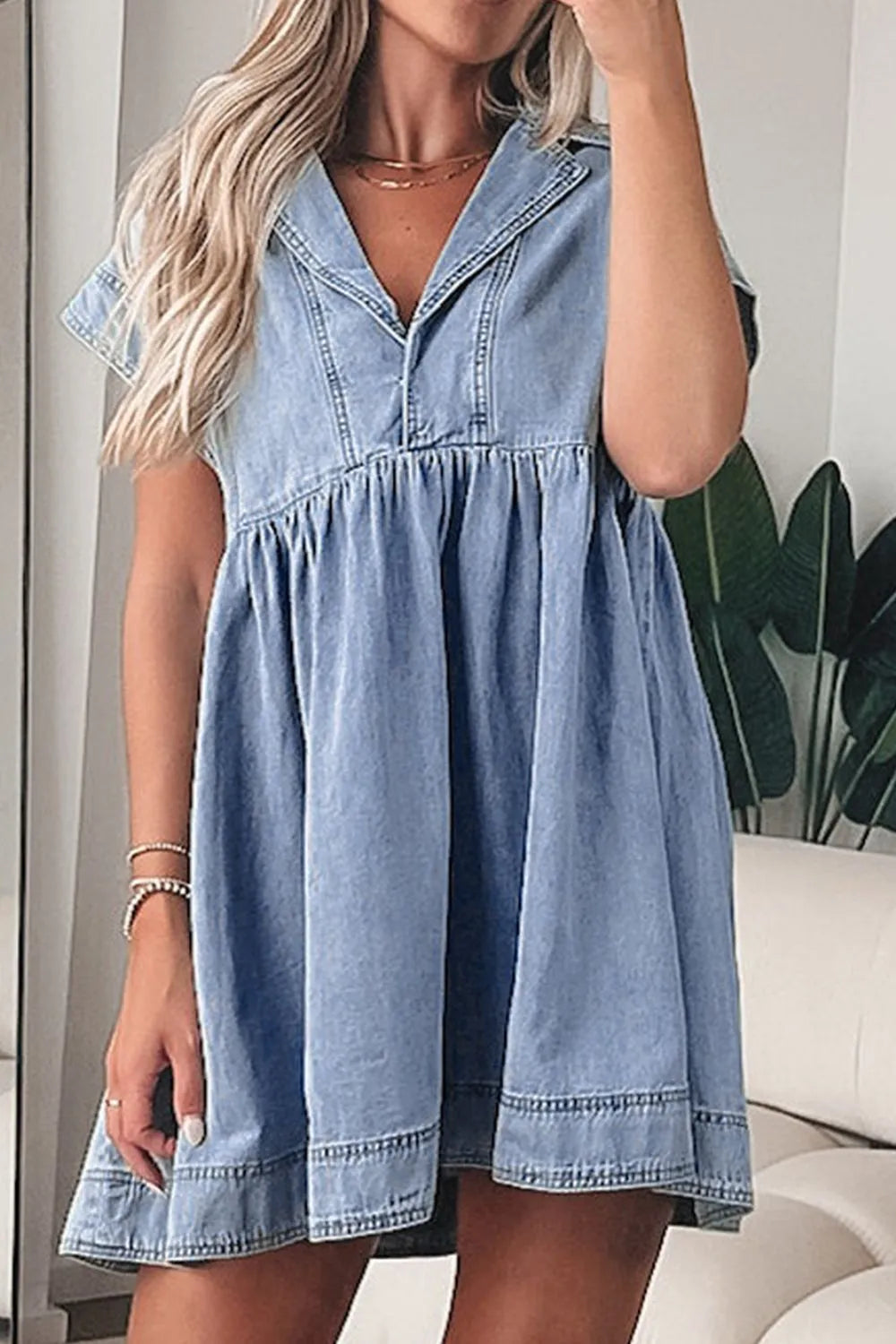 Medium-sized denim babydoll dress with lapel collar and cap sleeves, featuring a stylish and casual design by Trendsi.
