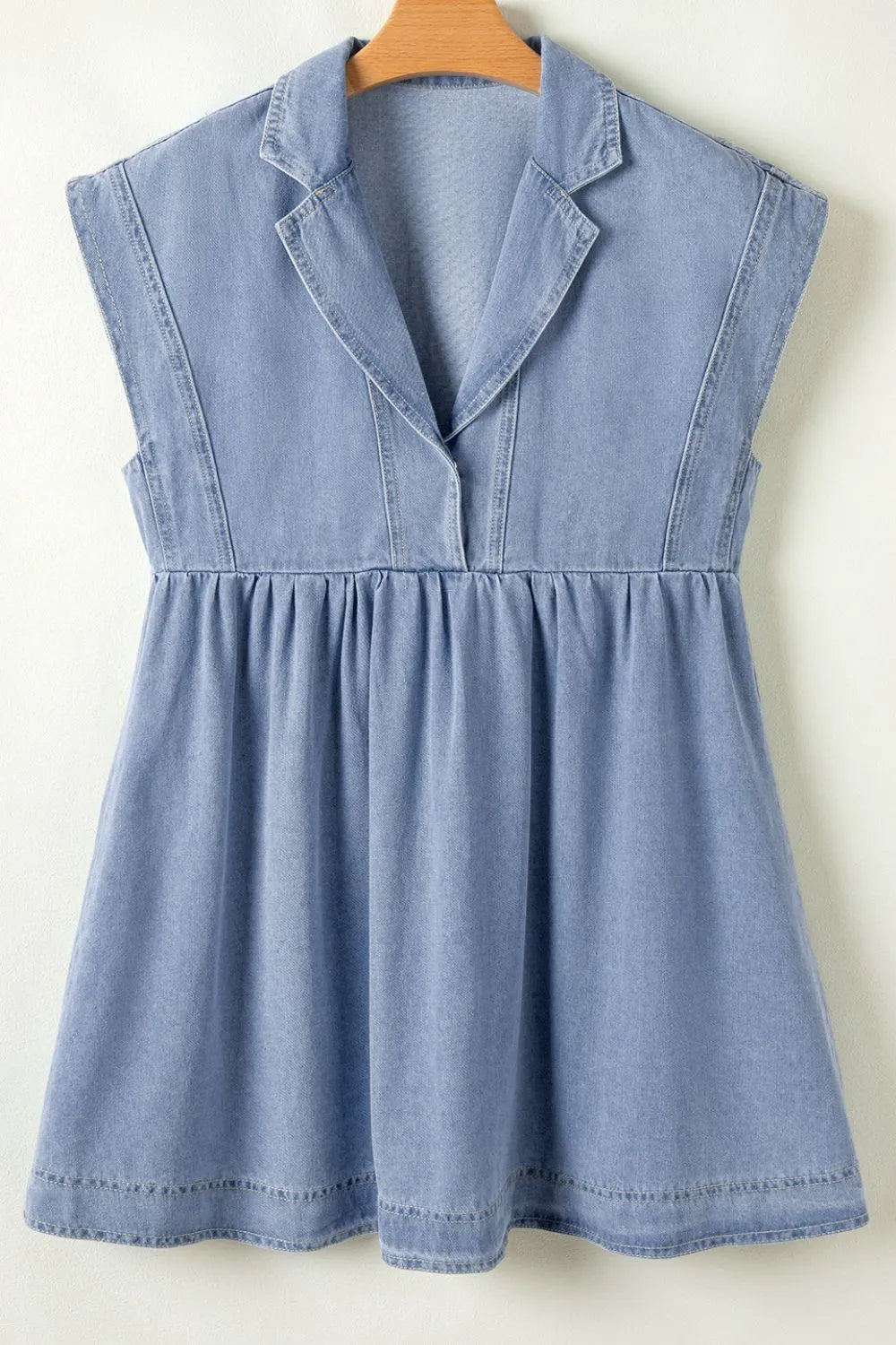 Light blue denim babydoll dress with lapel neckline and cap sleeves, styled by Trendsi.