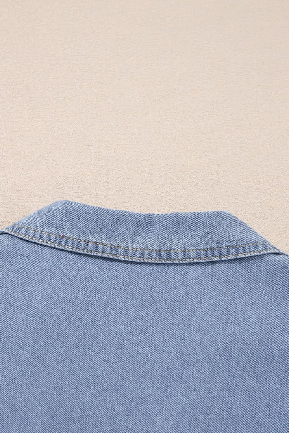 Medium-length denim babydoll dress with lapel neckline and cap sleeves from Trendsi, shown on a model.