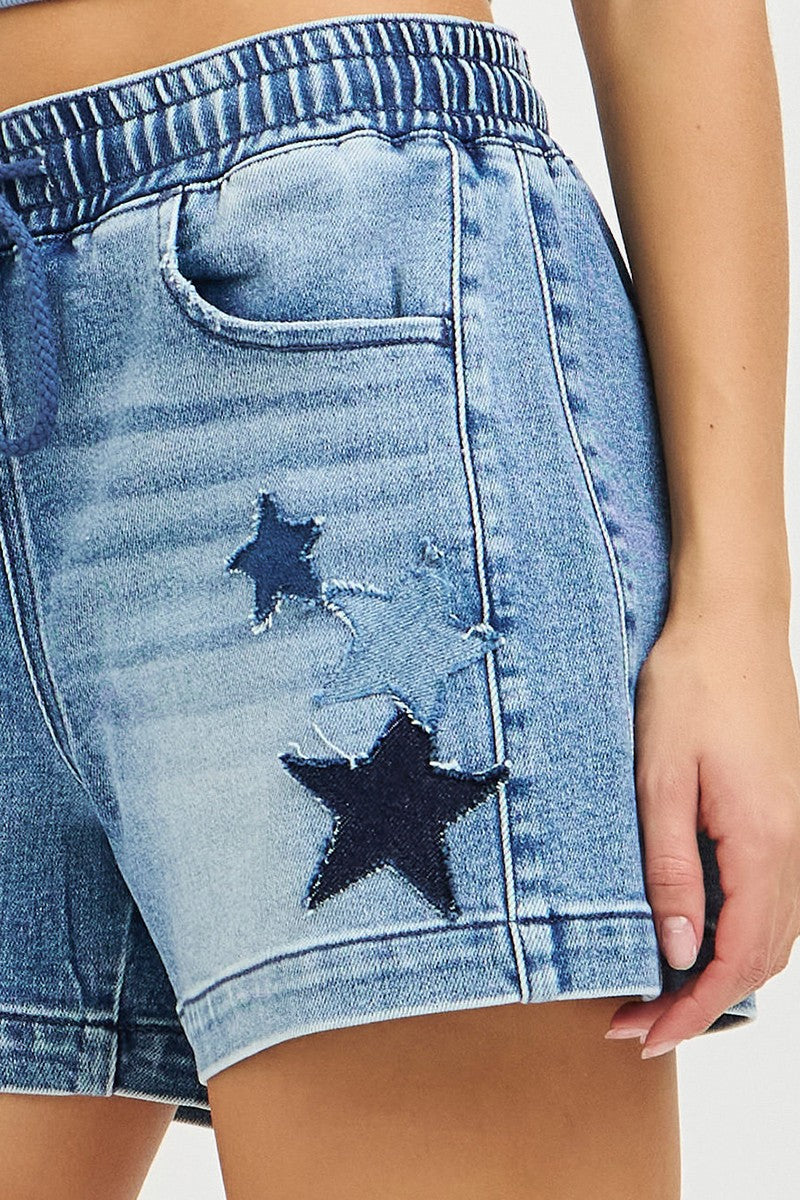 Risen elastic band slouchy denim shorts with star patch details, casual summer style, trendy distressed look, and relaxed fit.