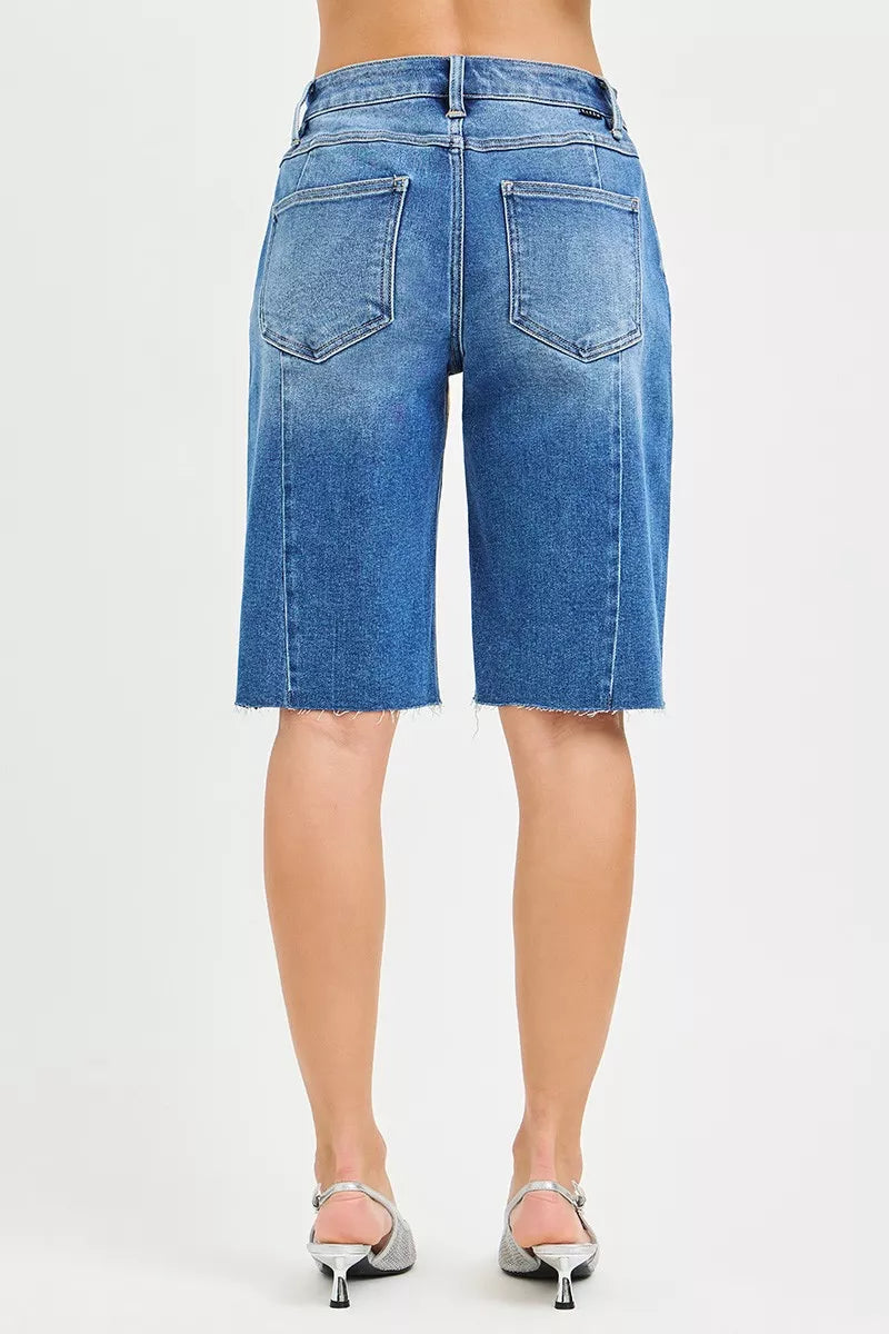 Medium image of RISEN Raw Hem Slouchy Seamed Jorts by Trendsi, showcasing the relaxed fit and distressed raw hem denim shorts.