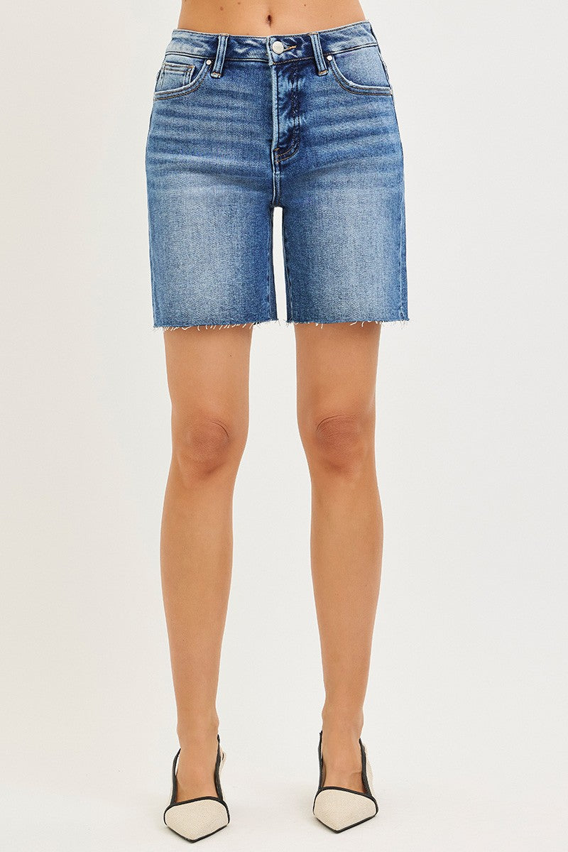 Medium wash Risen Tummy Control high-rise raw hem denim shorts by Trendsi, featuring a fitted waist and distressed raw cut hem.