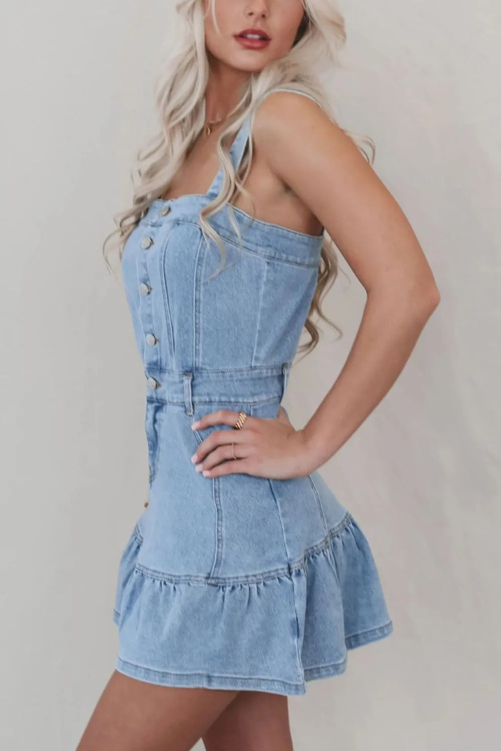 Light blue denim dress with ruffled hem, button front, and square neckline from Trendsi, displayed on a hanger.