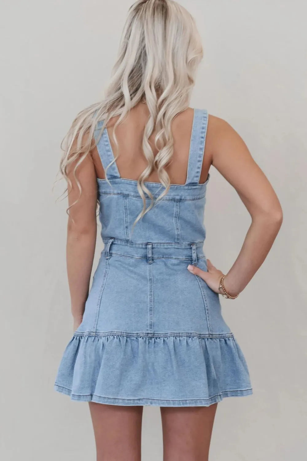 Light blue denim dress with ruffled hem, square neckline, and button front from Trendsi, styled with casual accessories.
