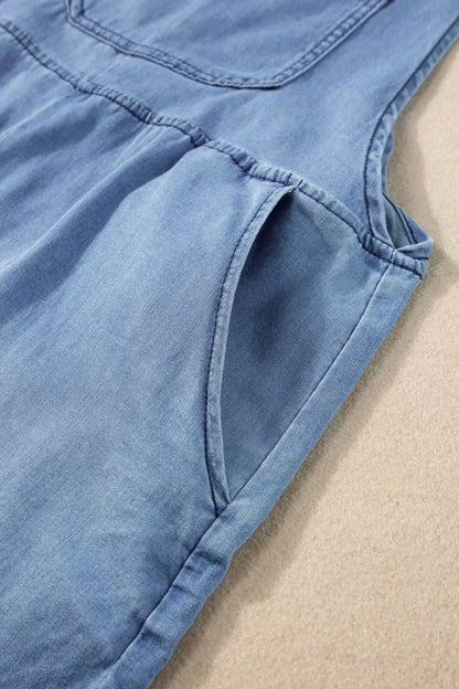 Square neck denim overalls with pockets from Trendsi, featuring a fitted design and classic blue denim fabric.