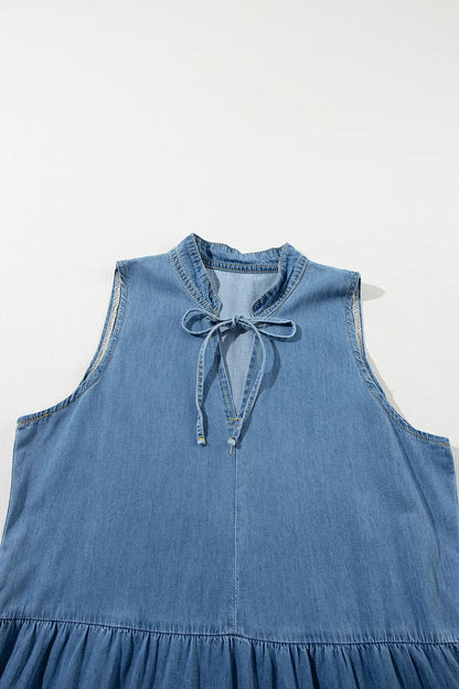 Medium-length denim maxi dress with a tie neck and tiered design from Trendsi, featuring long sleeves and a flowy silhouette.