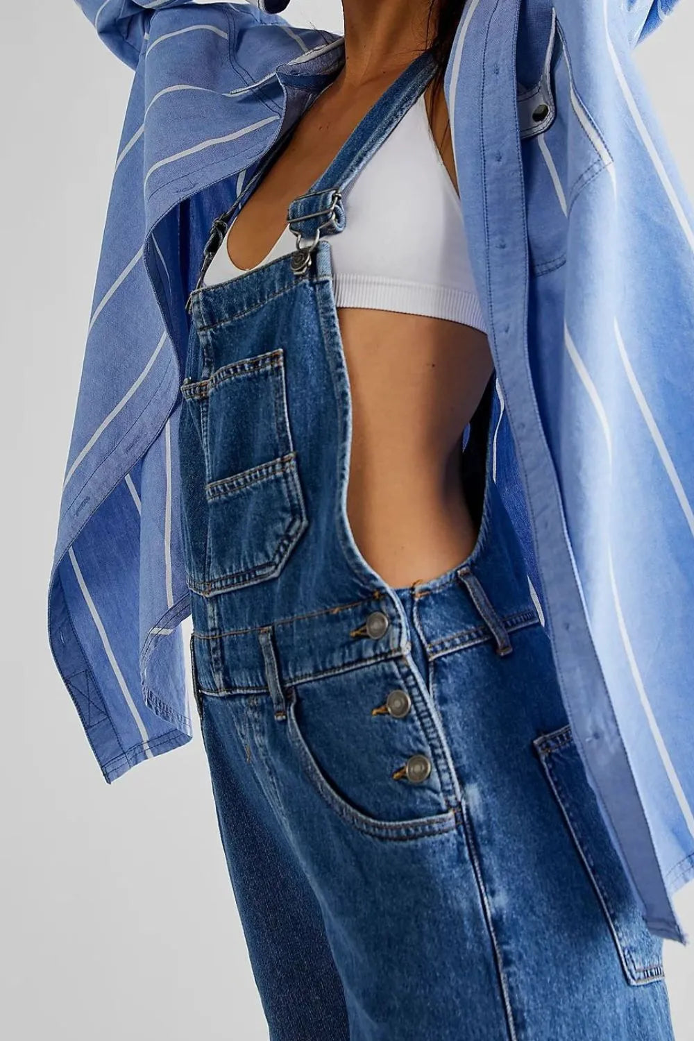 Medium shot of Trendsi wide strap square neck denim overalls hanging on a display mannequin.