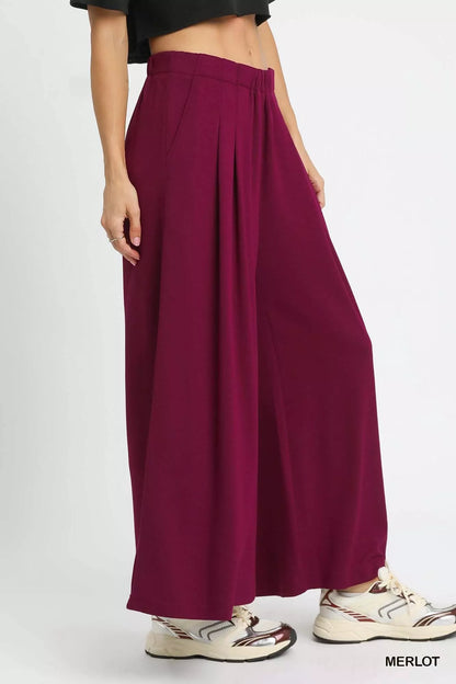 Merlot-colored Umgee wide-leg pants with pockets, featuring a relaxed fit and casual style, perfect for comfortable everyday wear.