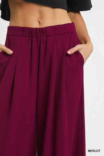 Umgee wide leg pants with pockets in merlot color, featuring a relaxed fit and stylish design.
