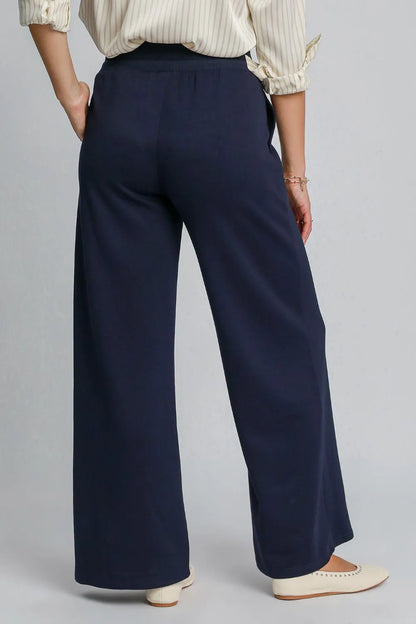 Midnight blue Umgee drawstring wide-leg pants with pockets, featuring a relaxed fit and casual style, by Trendsi.