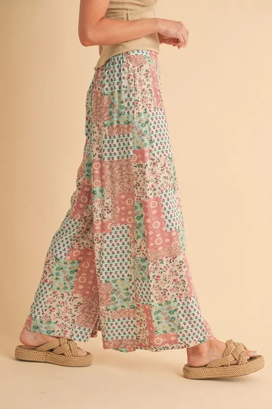 Mint pink Aemi+Co printed wide-leg pants by Trendsi, featuring a relaxed fit and stylish floral pattern.