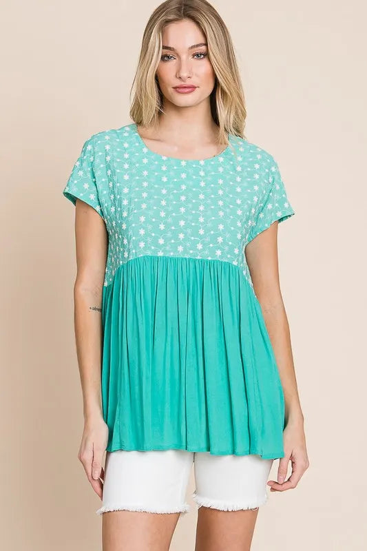 Plus size Lime 'N' Chili embroidered short sleeve pleated babydoll top by Trendsi, featuring vibrant embroidery and a relaxed fit.