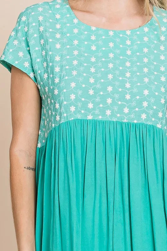 Plus size Lime 'N' Chili embroidered short sleeve pleated babydoll top by Trendsi, showing the detailed embroidery and pleated design.