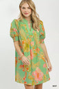 Mint green Umgee botanical print dress with smocked cuffs, featuring a flowy silhouette and vibrant floral pattern.