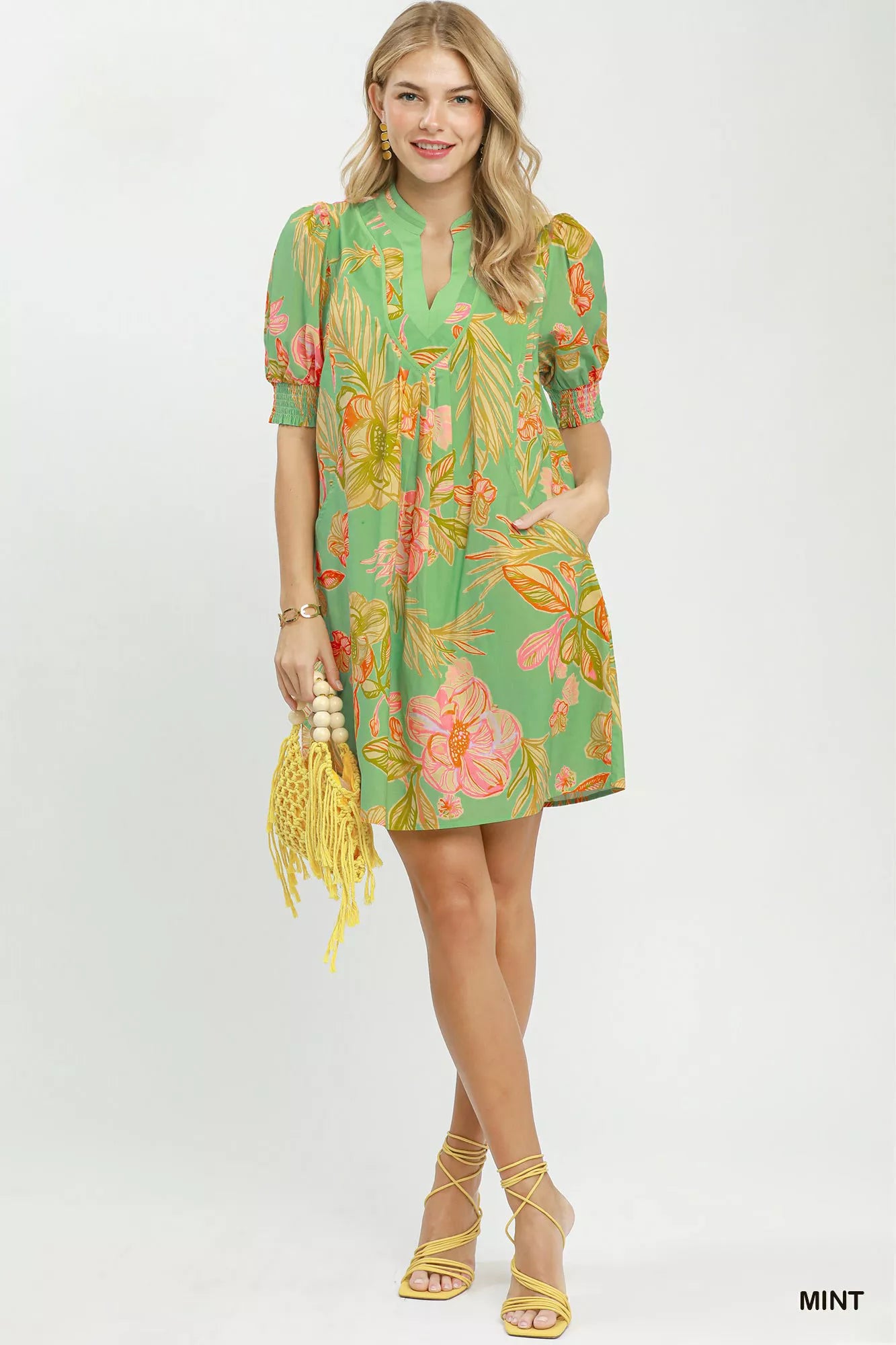 Mint green Umgee botanical print dress with smocked cuffs, featuring a flowy silhouette and floral pattern.