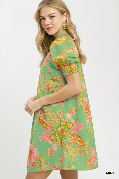 Mint green Umgee botanical print dress with smocked cuffs, featuring a flowy design and floral pattern, by Trendsi.