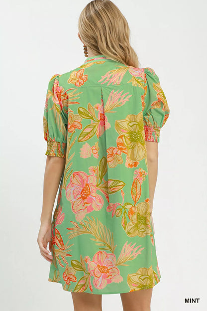 Mint green Umgee botanical print dress with smocked cuffs, featuring a flowy silhouette and floral pattern.