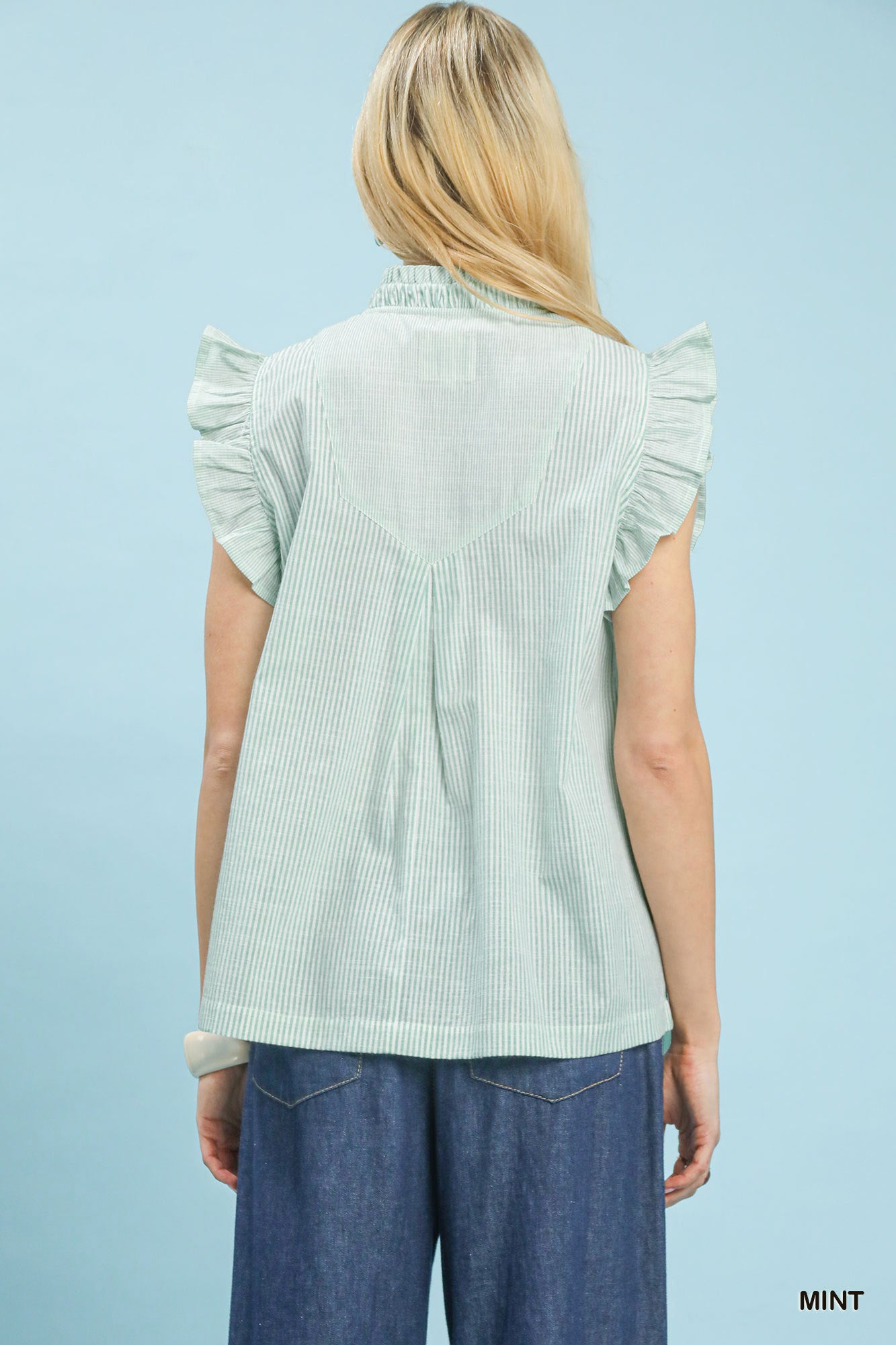 Mint green Umgee embroidered ruffle sleeve popover top with floral embroidery and relaxed fit, styled on a model.
