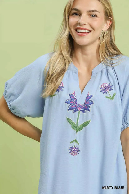 Umgee embroidered floral babydoll dress in misty blue with delicate embroidery and a flowy silhouette, perfect for casual or dressy occasions.