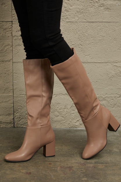 Mocha knee-high boots from East Lion Corp by Trendsi featuring block heels and sleek design.
