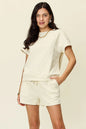 Trendsi mocha double take full-size textured short sleeve T-shirt with matching drawstring shorts set on a model.