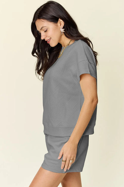 Trendi mocha-colored full-size texture short sleeve T-shirt and drawstring shorts set, casual and comfortable for everyday wear.