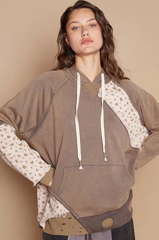 Mocha floral patchwork distressed drawstring hoodie by Trendsi, featuring a casual, stylish design with floral and patchwork details.