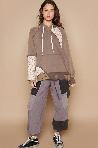 Mocha floral patchwork distressed drawstring hoodie by Trendsi, featuring casual style and cozy fabric with floral and patchwork design.