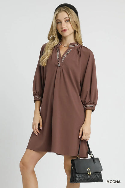 Mocha Umgee notched shift dress with trim detail, showcasing a stylish sleeveless dress with a relaxed fit and decorative trim.