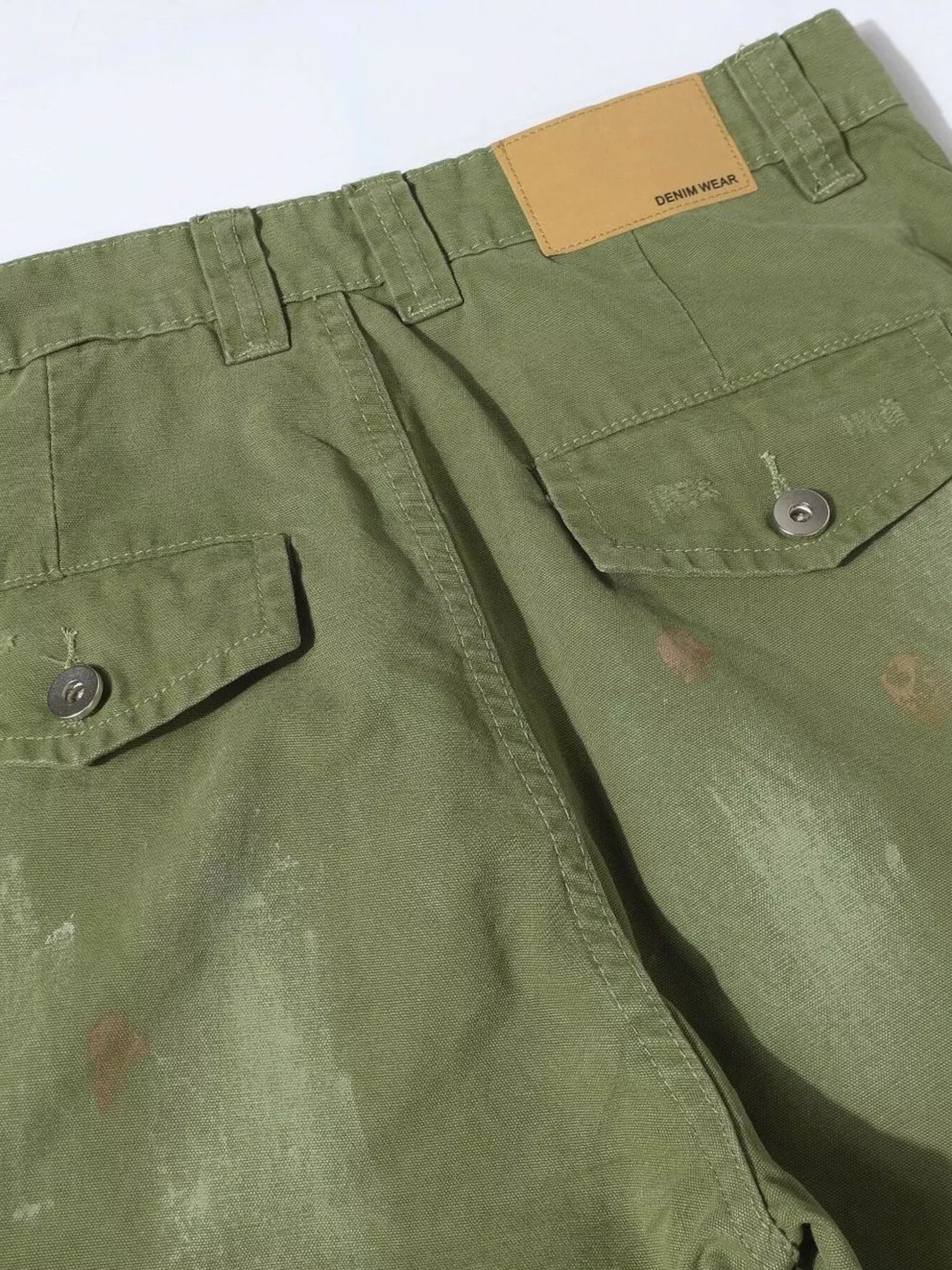 Men's distressed cargo pants with paint splatter from Trendsi, featuring rugged design and multiple pockets.